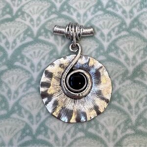Necklace Pendant. Silver-tone Featuring a Swirl Design with Black Center Stone.